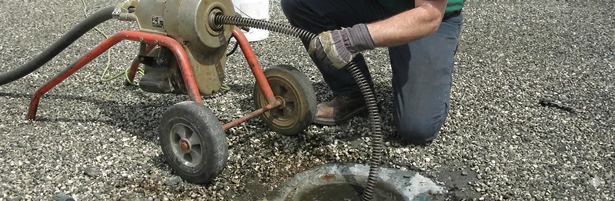 sewer rodding technician actively removing blockages from a sewer line in Seattle, WA
